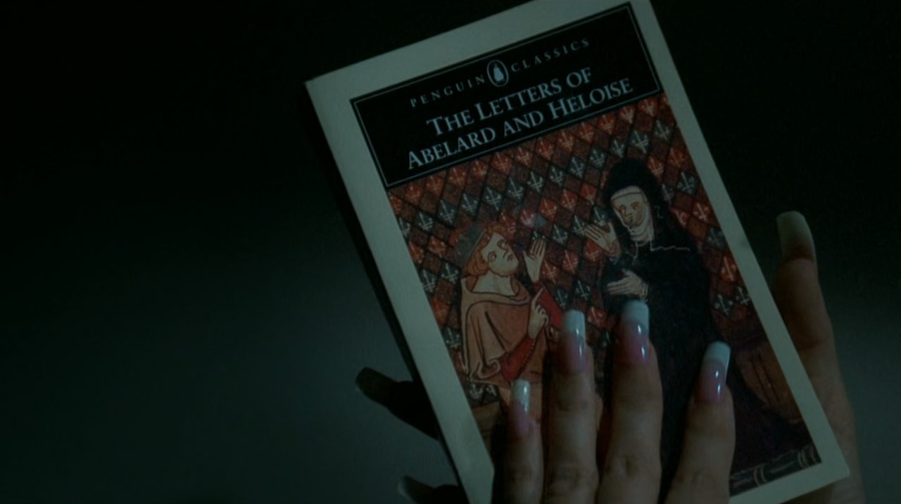 Carmella Soprano's pink fingernails press against the cover of a book, 'The Letter of Abelard and Heloise.'